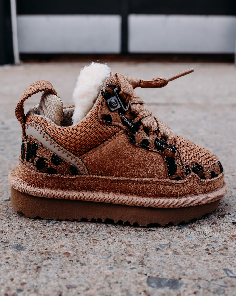 fur lined chestnut colored tennis shoe with leopard sheepskin details