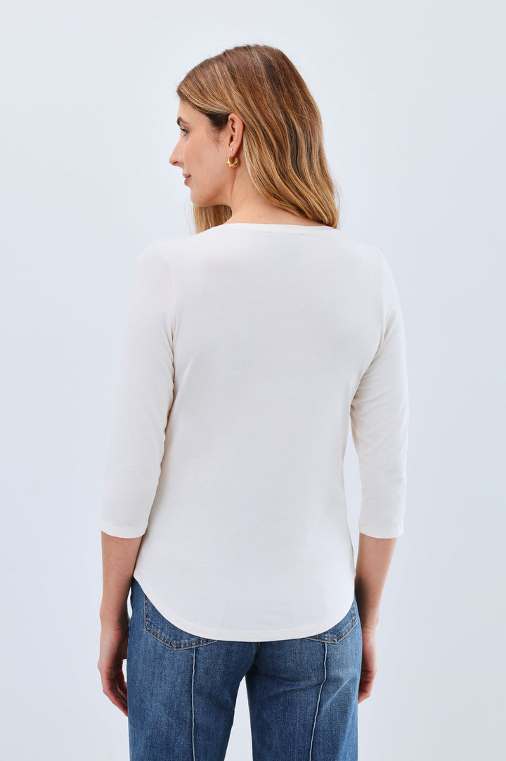 Woman modeling French Dressing Jeans cream 3/4 sleeve v-neck top with blue jeans, back view