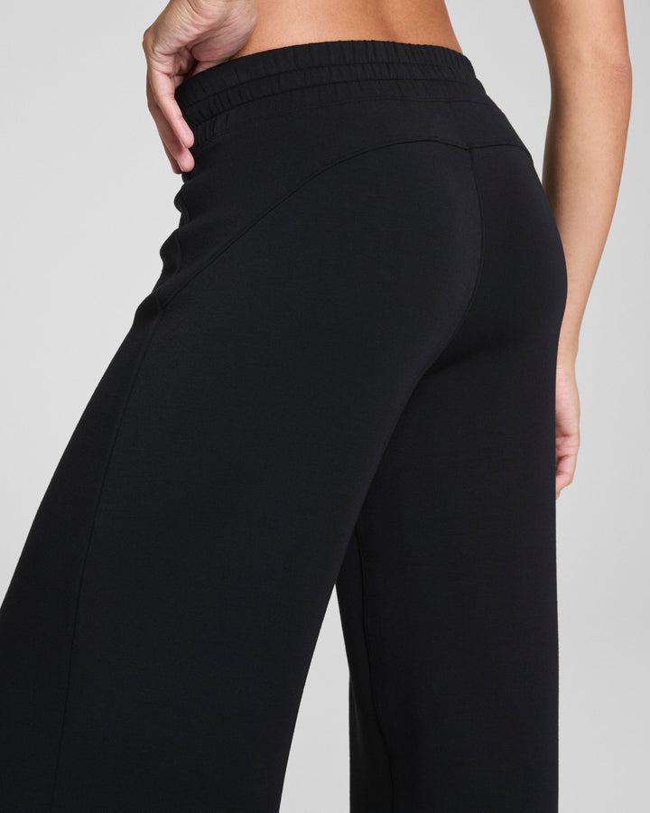 Close-up of black wide leg pants showing fit and fabric detail