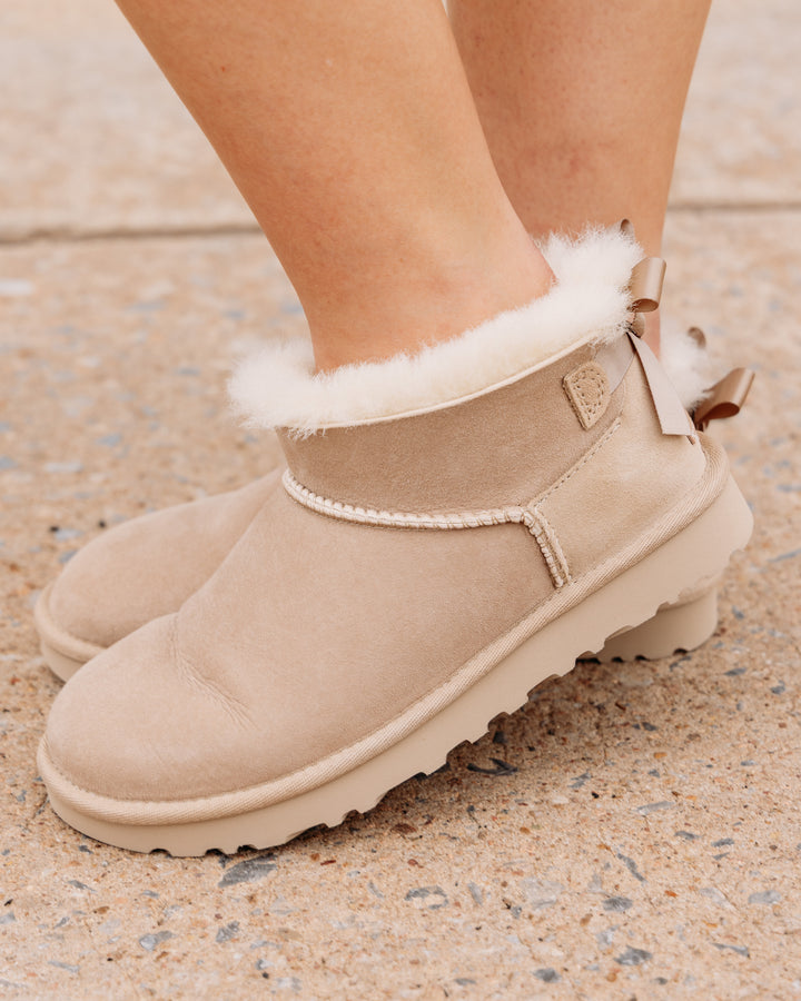 UGG: Ultra Mini Bailey Bow Boot in Sand (1185491)