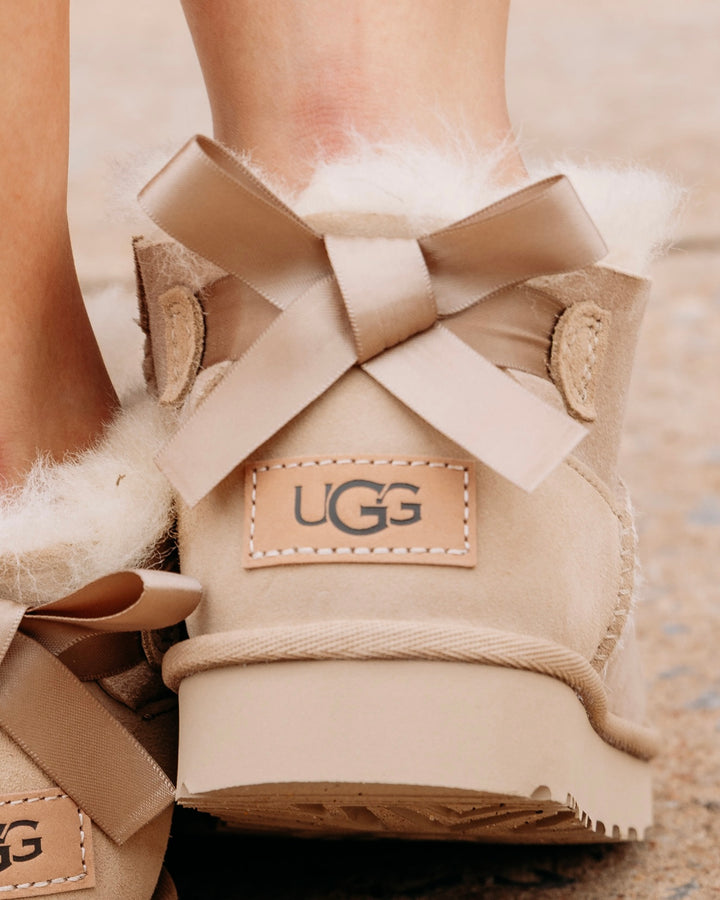 UGG: Ultra Mini Bailey Bow Boot in Sand (1185491)