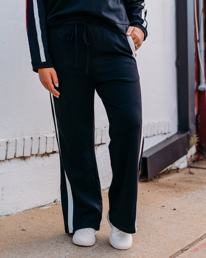 Jodifl: Track Pant in Black, Red, and Black