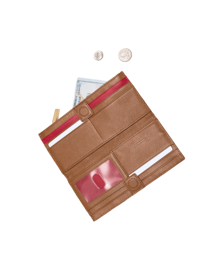 Hammitt 110 North wallet open showing tan pebbled leather red interior card slots and coins