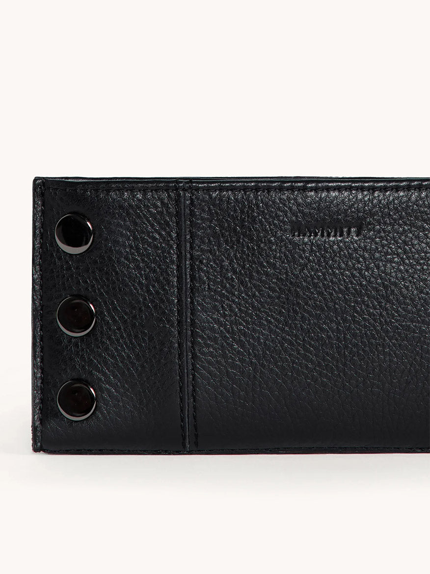 Hammitt 110 North wallet in black pebbled leather with gunmetal snap closures, detail view