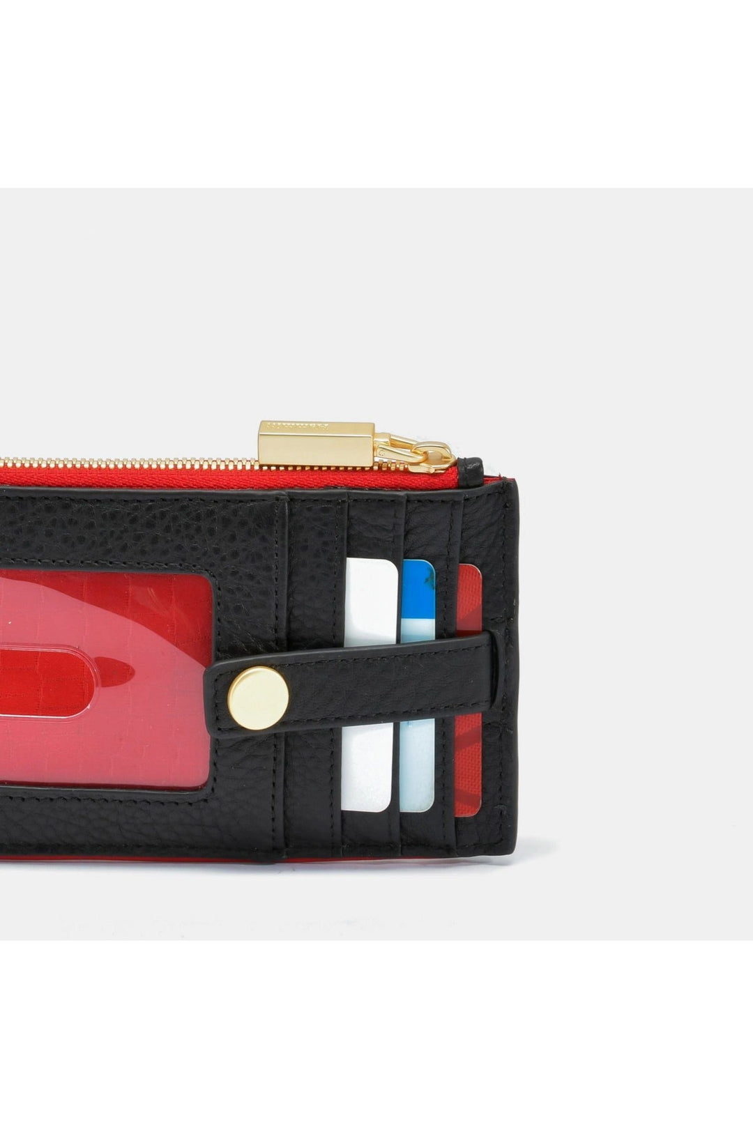 Hammitt 210 West card wallet in black leather with red zip and gold hardware detail shot