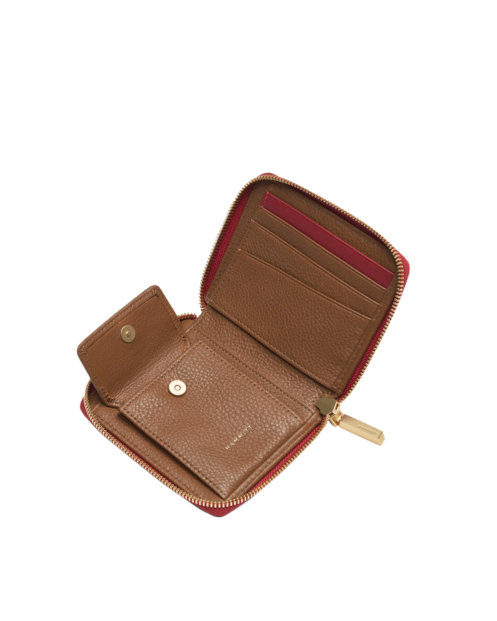 Hammitt 5 North wallet open showing tan interior, card slots, and red zip with gold hardware