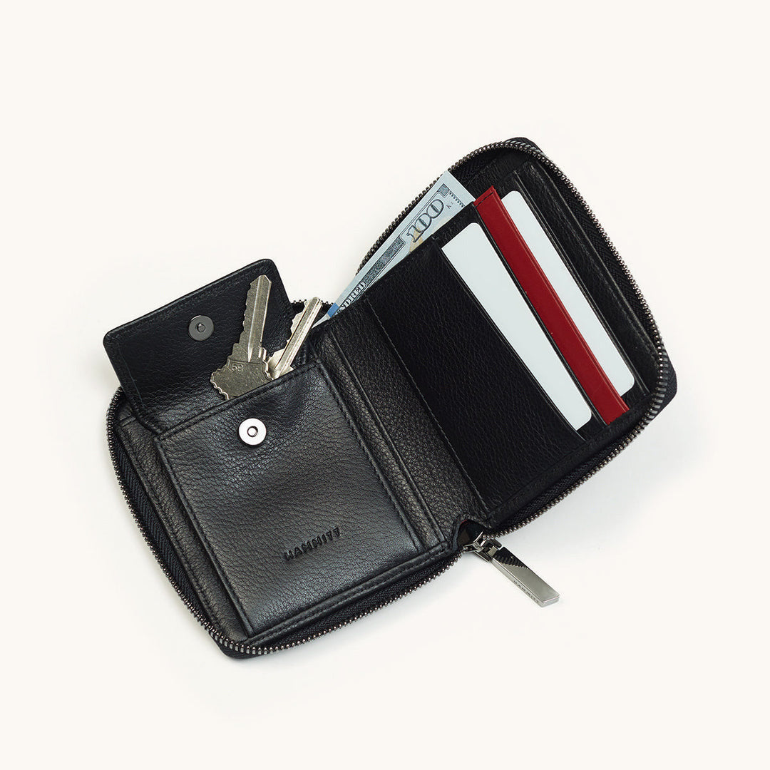 Hammitt 5 North black leather zip wallet open showing keys, cash, and card slots