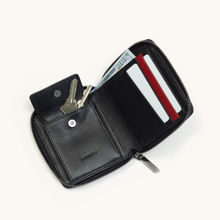 Hammitt 5 North black leather zip wallet open showing keys, cash, and card slots
