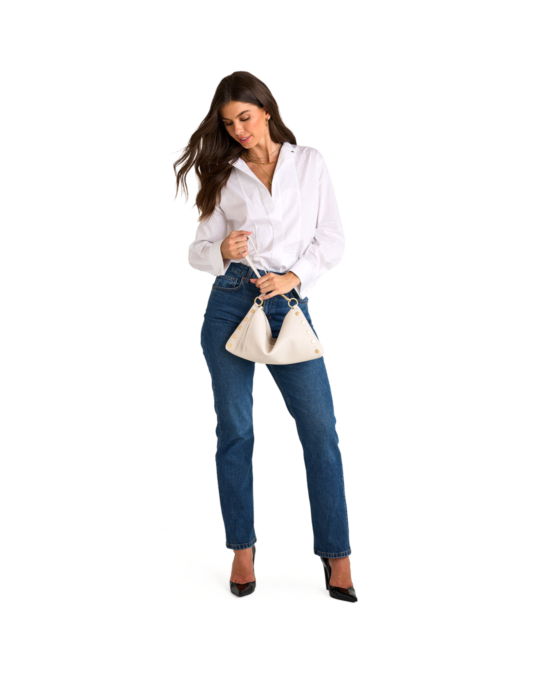 Model holding Hammitt Kyle Med bag in calla lily white with brushed gold hardware