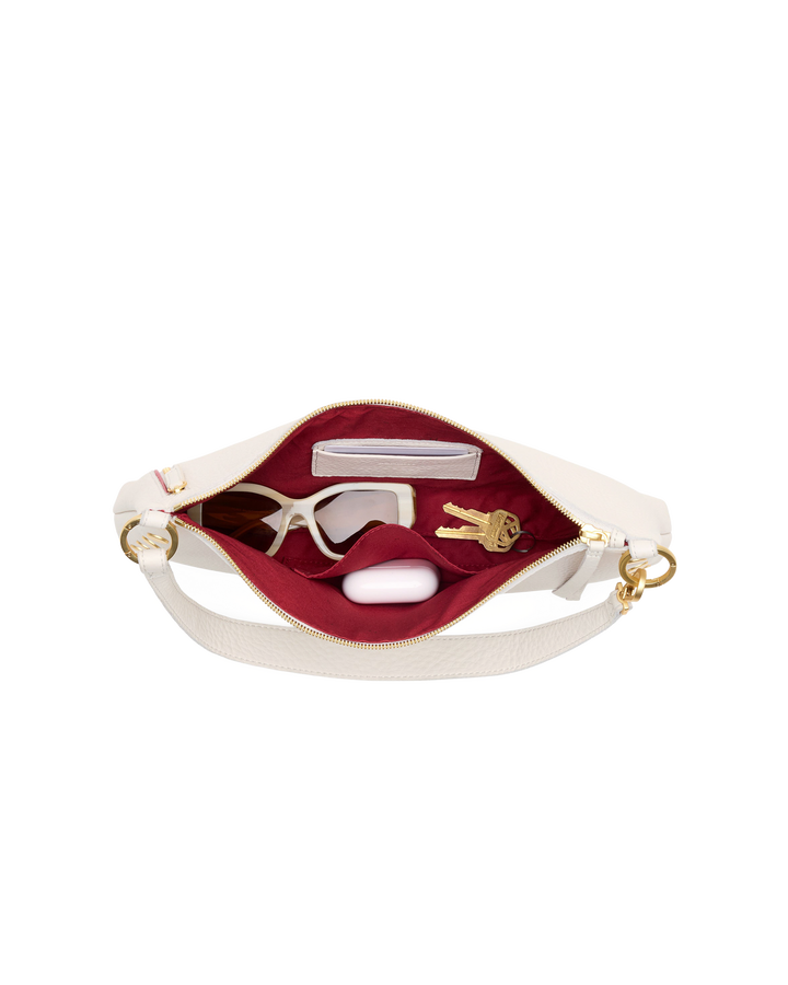 Hammitt Kyle Med bag in calla lily white open top view showing red interior with accessories