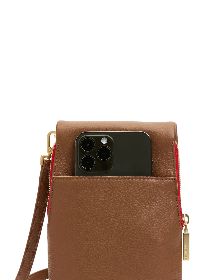 Hammitt VIP Mobile crossbody bag in mahogany pebble leather with red zip and iPhone shown inside
