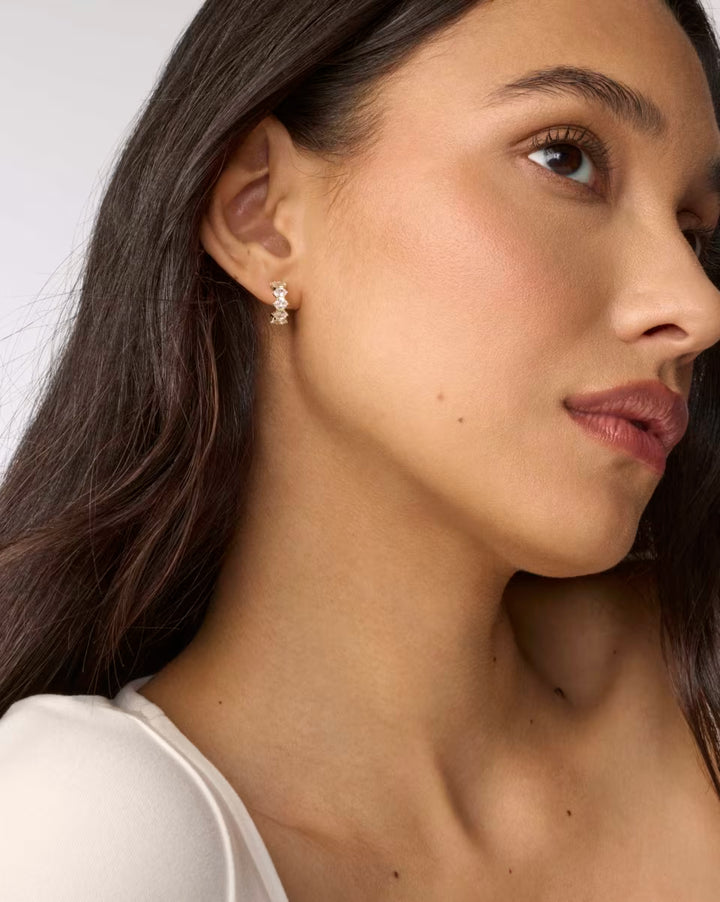 Kendra Scott: Cailin Gold Crystal Huggie Earrings in White Crystal - The Vogue Boutique