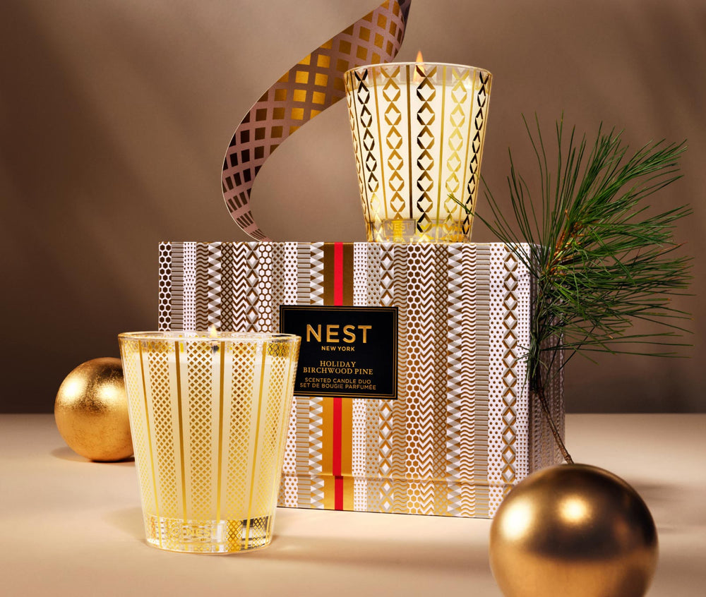 Nest New York Holiday Birchwood Pine Scented Candle Duo Set with gold patterned glass vessels and decorative gift box