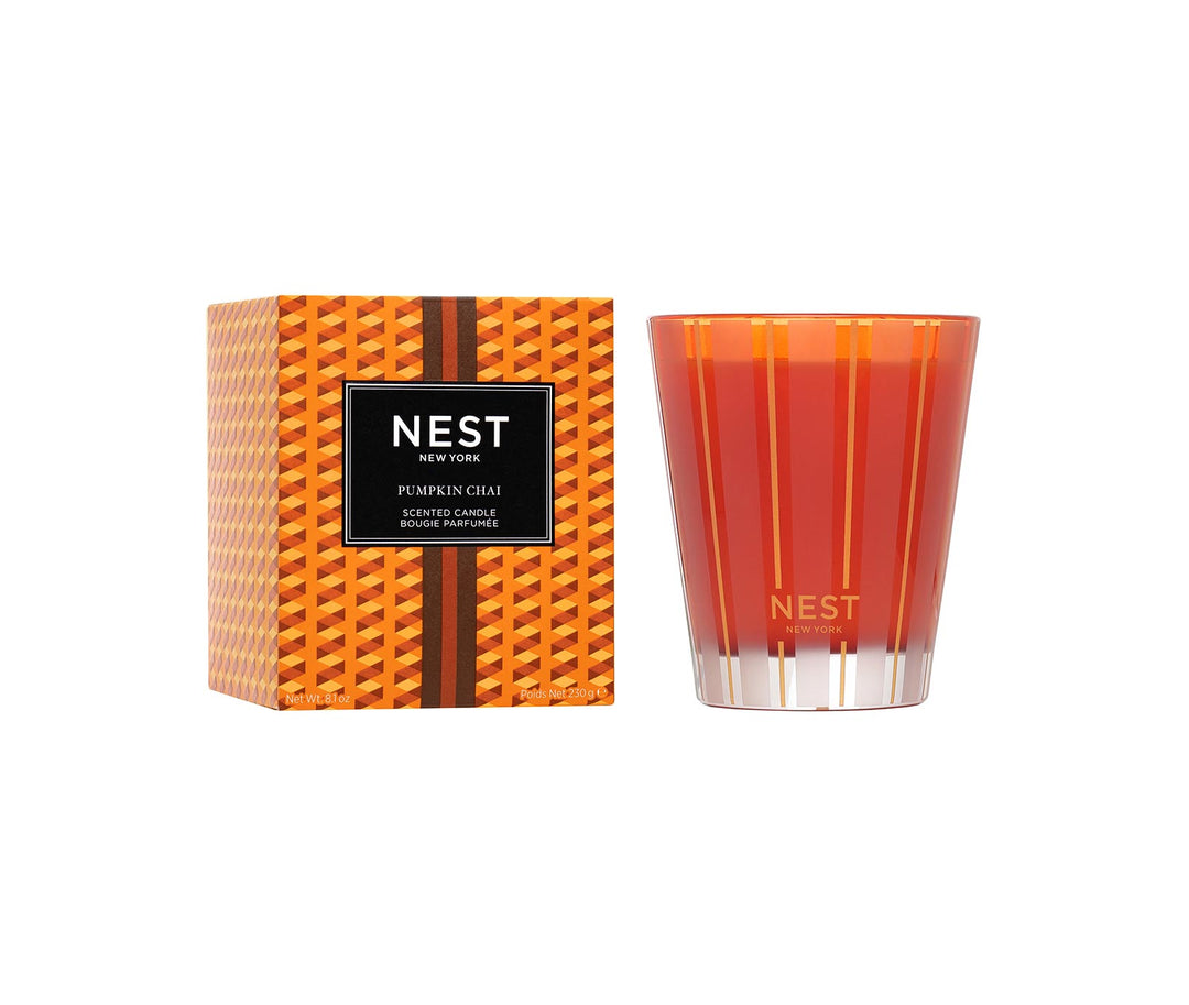 NEST New York Pumpkin Chai Classic Candle 8.1oz in orange-red vessel with gold stripes and matching box