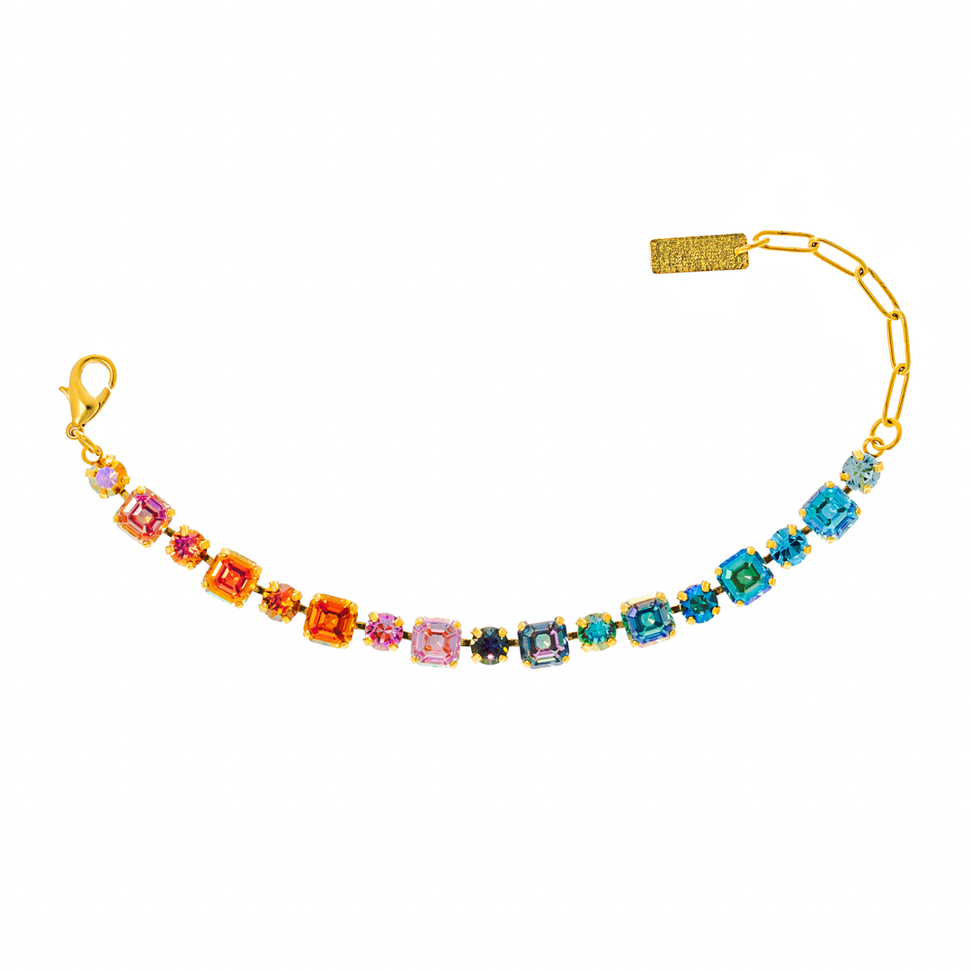 Gold bracelet with colorful square gemstones in rainbow gradient pattern