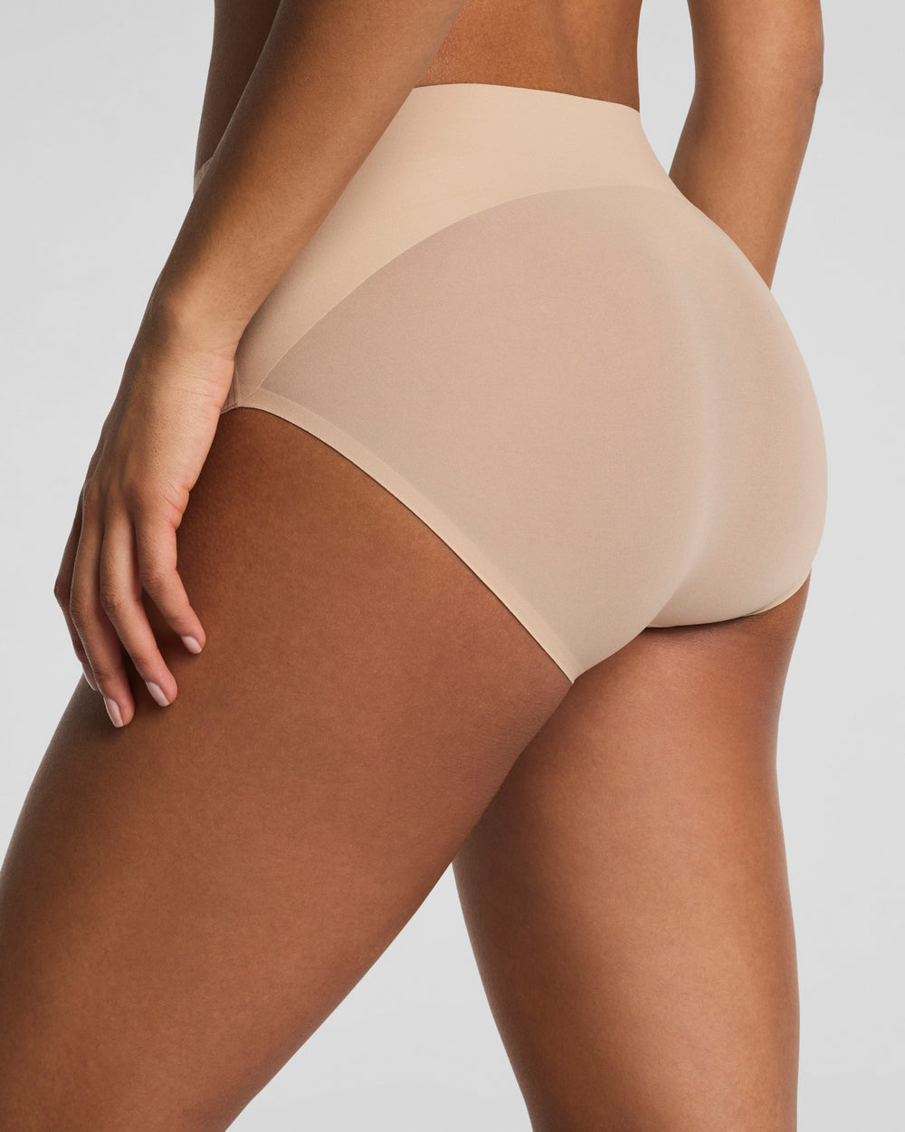 Spanx Undie-Tectable Brief in chai nude color shown on model from back