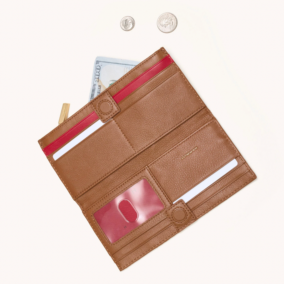 Hammitt 110 North wallet open showing mahogany pebble leather with red zip interior and card slots