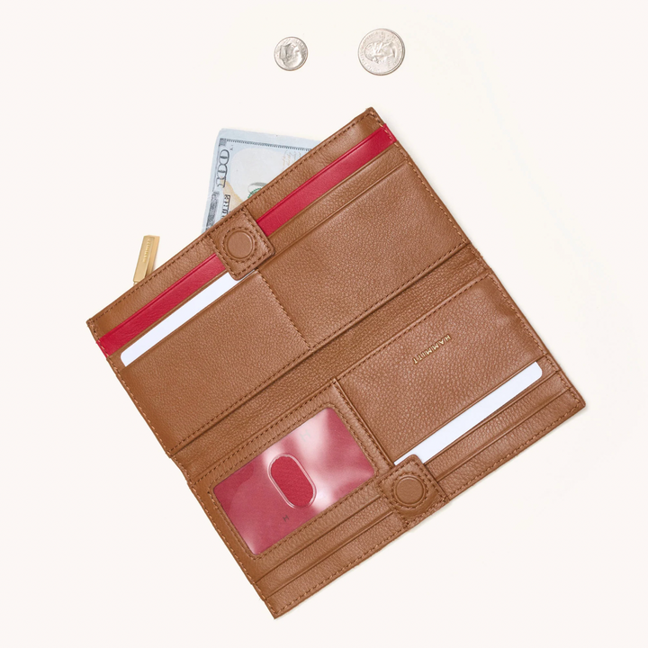 Hammitt 110 North wallet open showing mahogany pebble leather with red zip interior and card slots