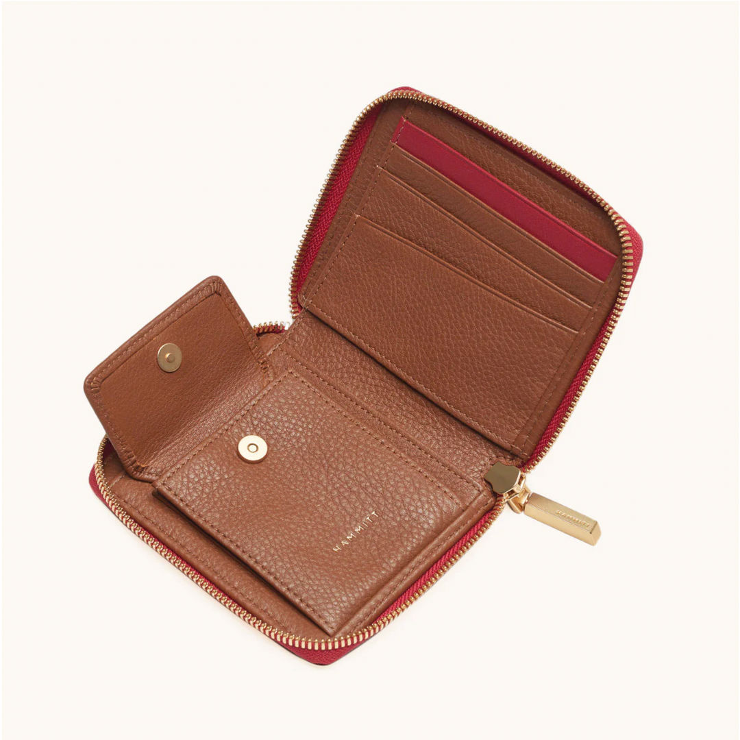 Hammitt 5 North wallet open showing tan leather interior with card slots and red zip