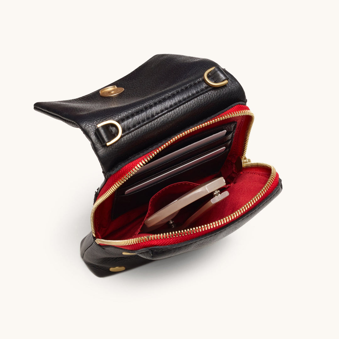 Hammitt VIP Mobile wallet open showing red interior lining, gold zipper, and card slots