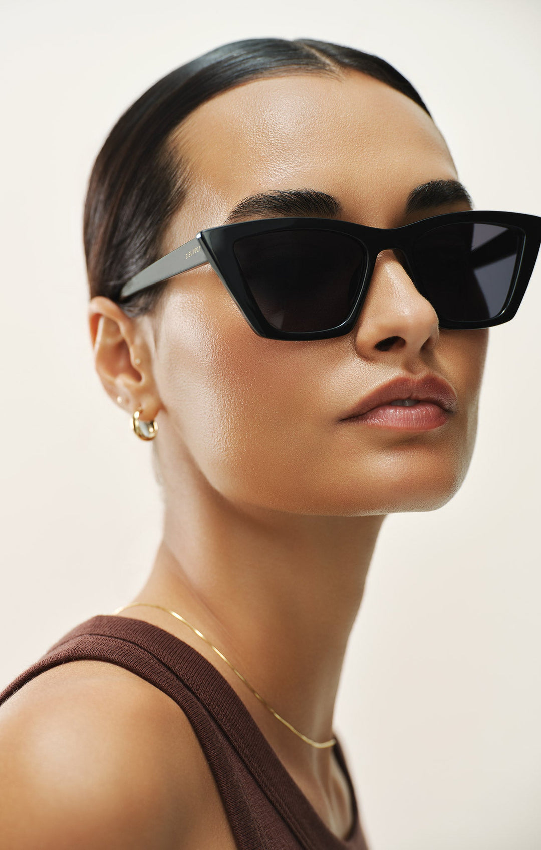 Woman wearing Z Supply Villa Carmel black cat-eye sunglasses with gradient polarized lenses