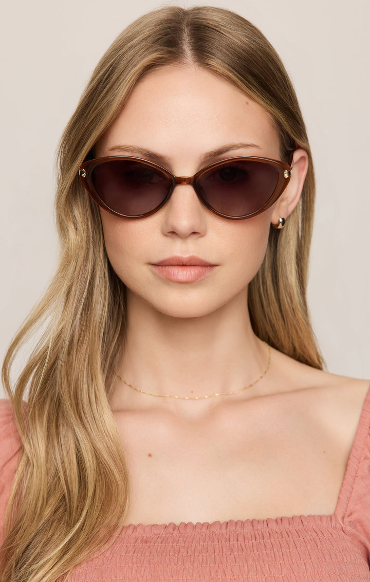 Woman wearing Z Supply Palermo cat-eye sunglasses in tortoise brown with gold accents