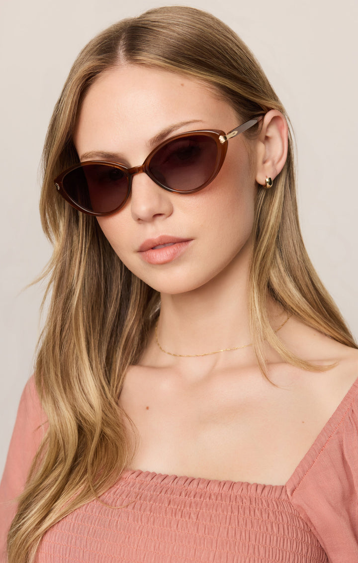 Woman wearing Z Supply Palermo cat-eye sunglasses in tortoise brown with gradient lenses