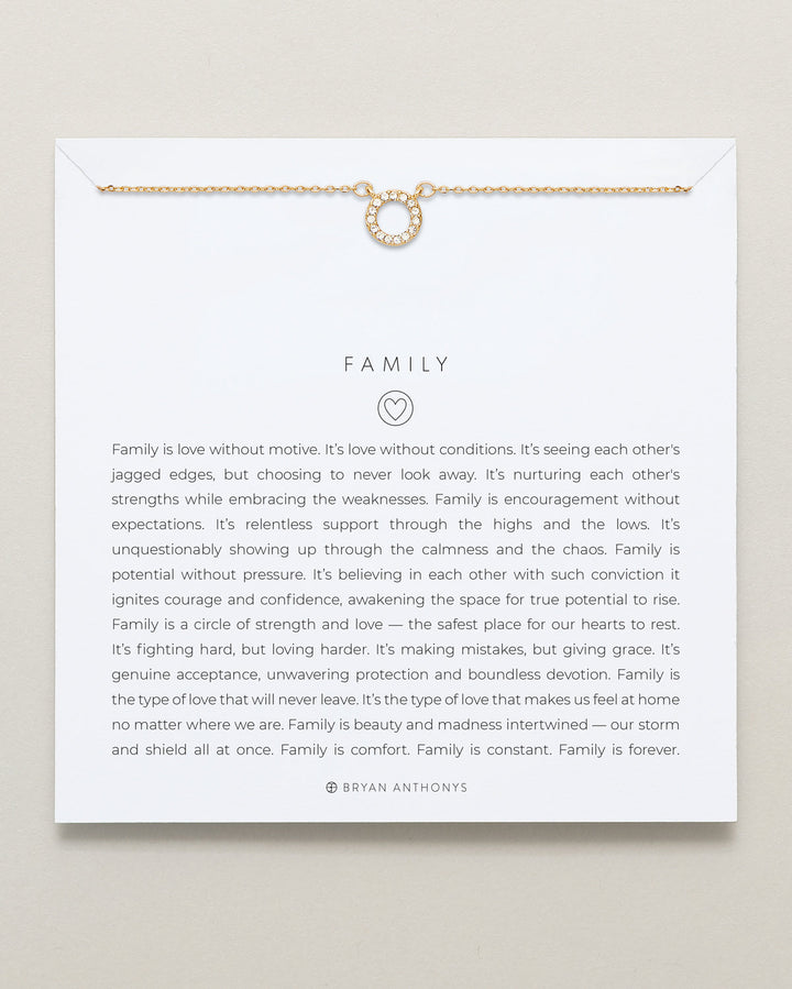 Bryan Anthonys Family necklace in 14k gold with circle pendant on white card