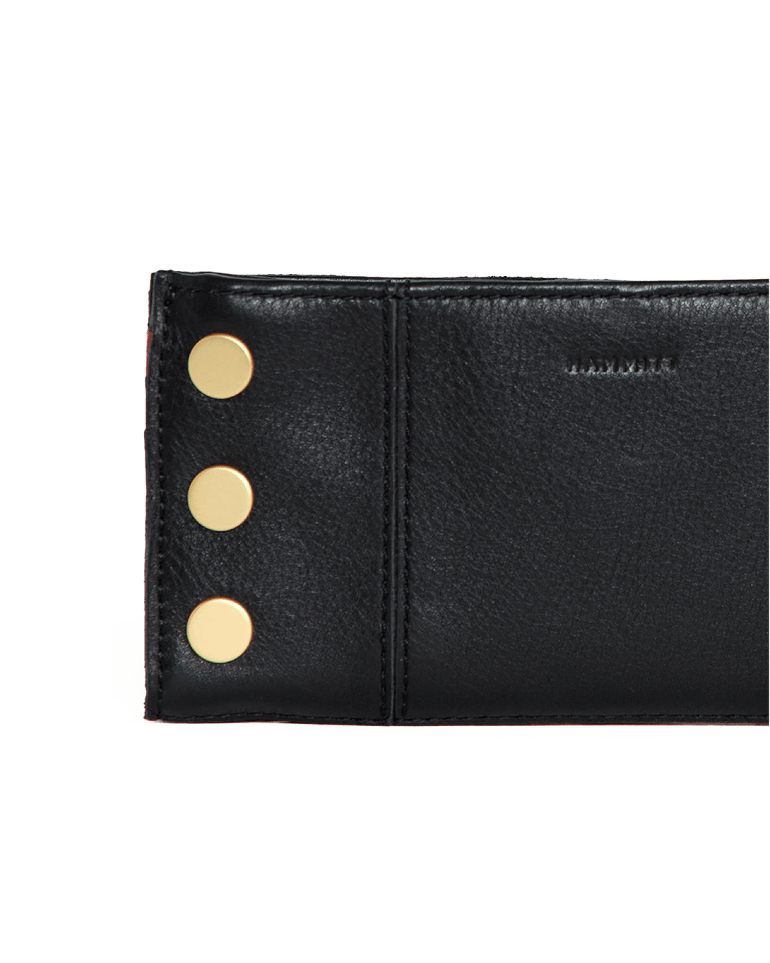 Hammitt 110 North wallet detail shot showing black leather with gold studs and red zip